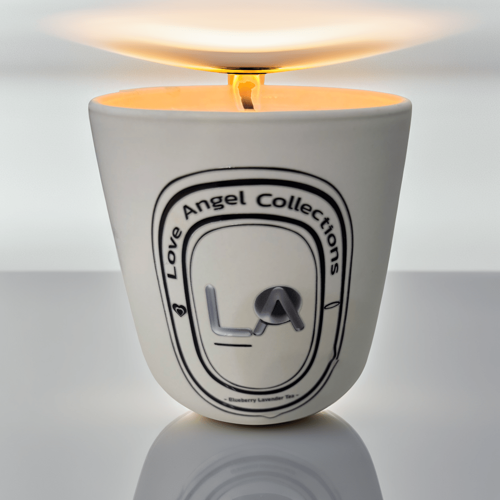 Love Angel Collections tea scented candle set in white container with lit wick and warm glow