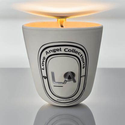 Love Angel Collections tea scented candle set in white container with lit wick and warm glow