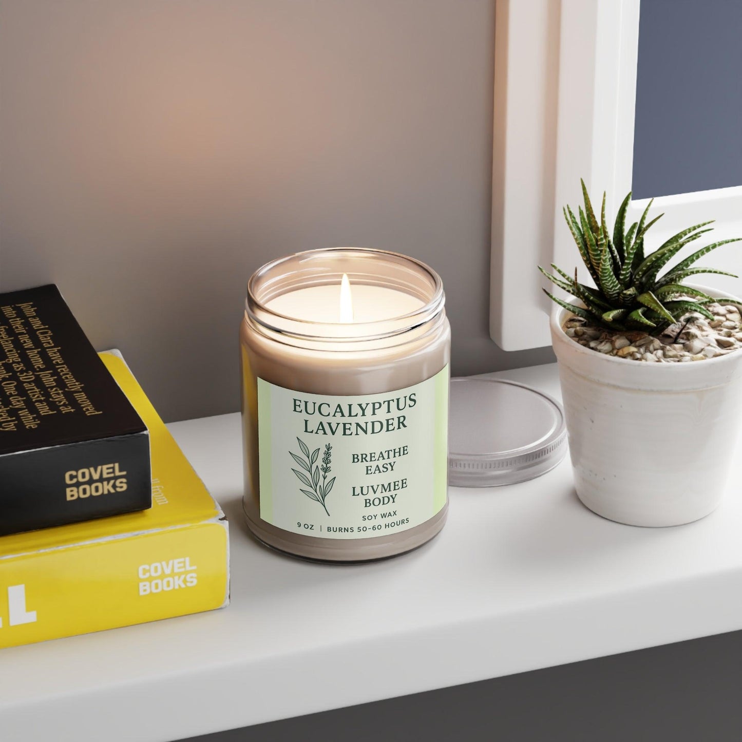 Eucalyptus lavender candle in a jar on a shelf with books and a small plant